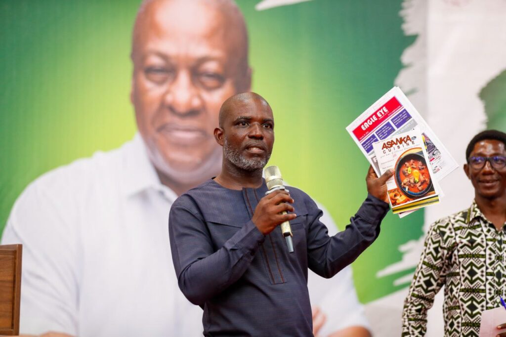 Dr. Daniel Edem Adzovie, displaying the creative projects of some students.